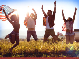 image of people jumping in a field